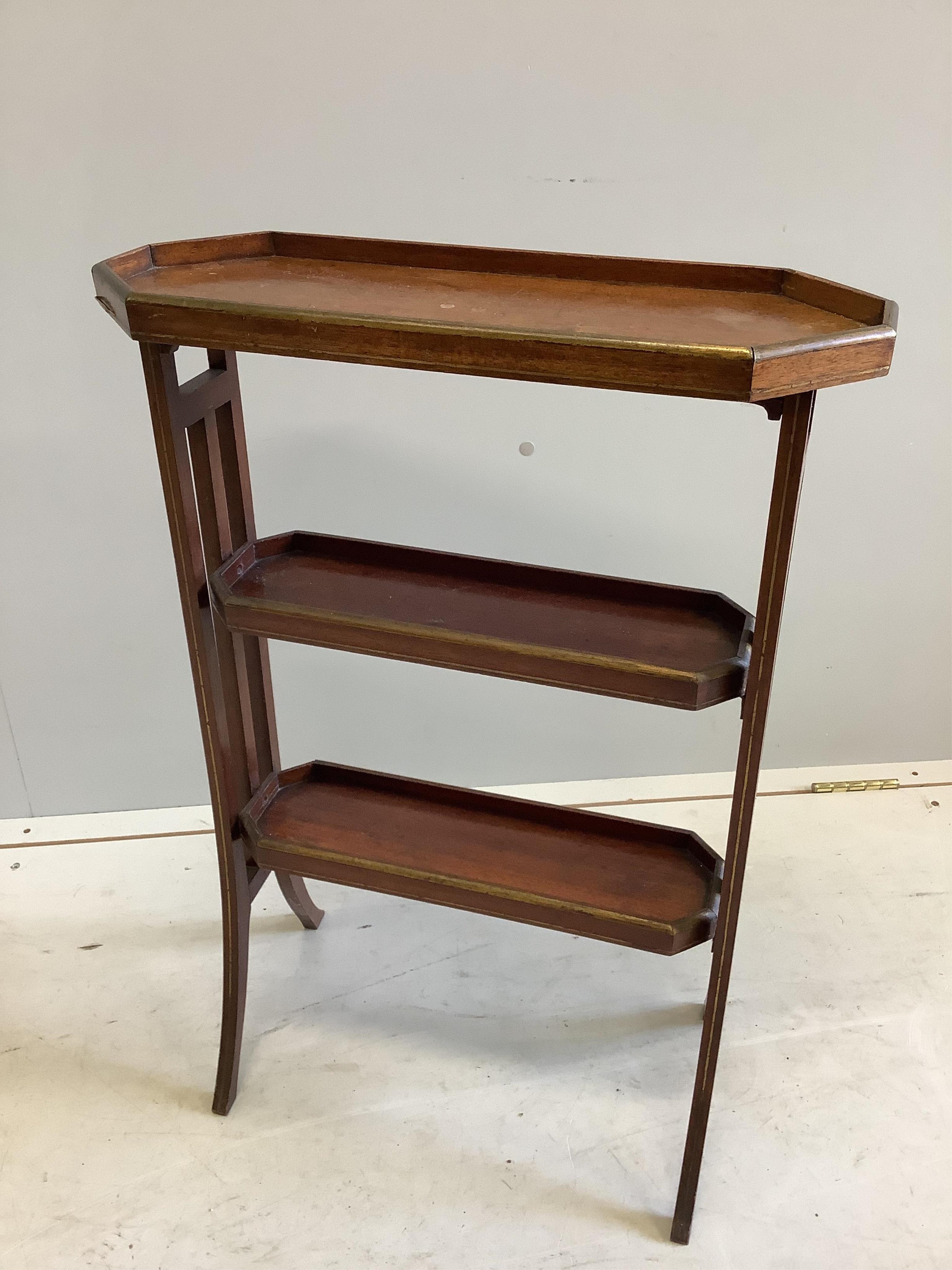 An Edwardian gilt metal mounted mahogany three tier table, width 51cm, depth 20cm, height 73cm. Condition - fair